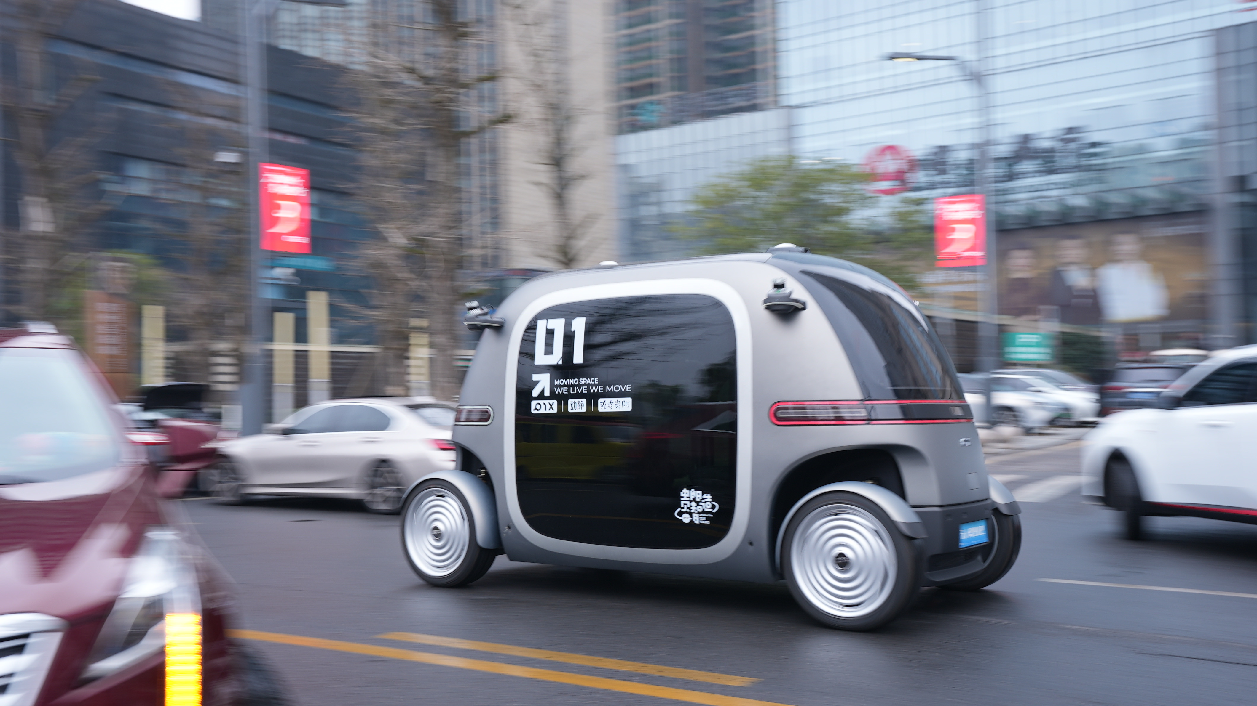 PIX RoboBus operating on a city road, demonstrating autonomous urban mobility