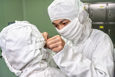 Operator wearing protective clothing inside a supplement manufacturing clean area