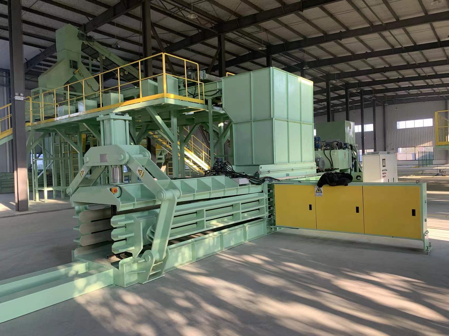 Vertical and horizontal waste paper baler configurations compared for footprint and throughput