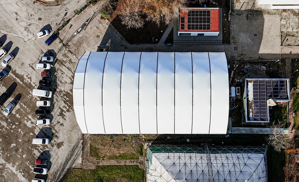 Aerial view of a large-span aluminum frame sports tent installed as an outdoor padel court structure