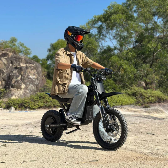 Freego X0 electric mini bike riding on rocky off-road terrain, demonstrating dirt ebike durability for extreme conditions