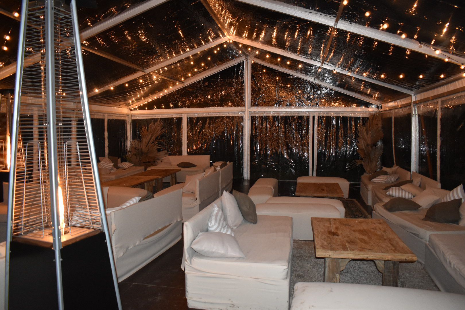 Transparent event tent with lights at night