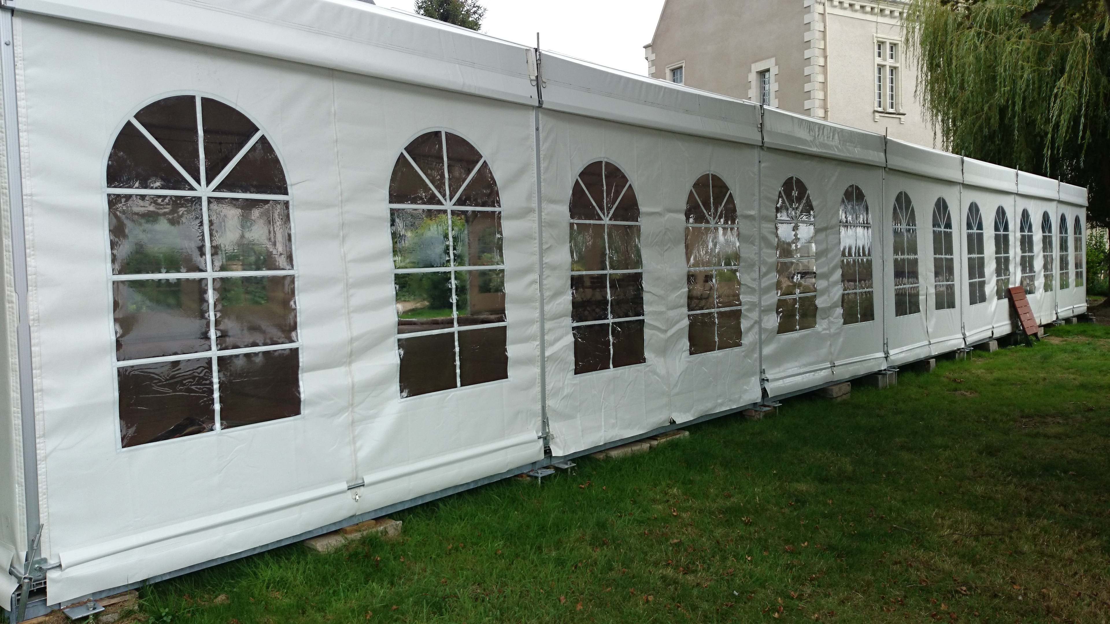 White arched window event tent used in a documented OEM application