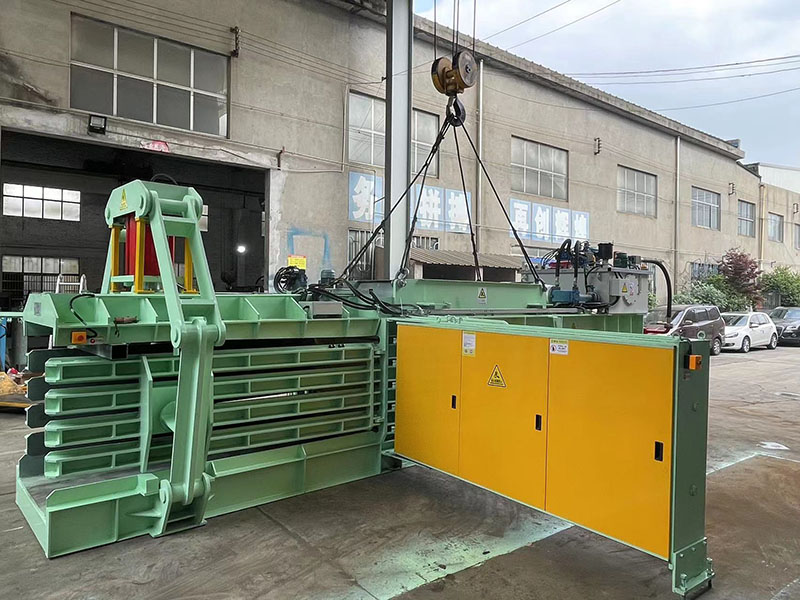 Full-automatic baler processing plastic bottles on a recycling line