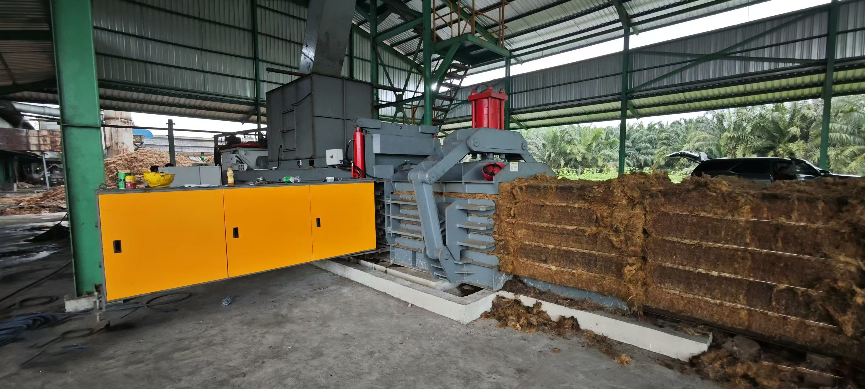 Horizontal baler in industrial setting