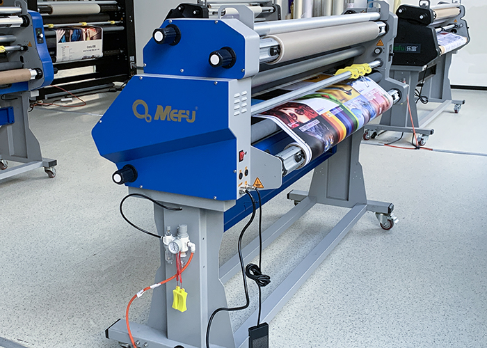 Wide-format roll laminator running production in a print finishing workshop