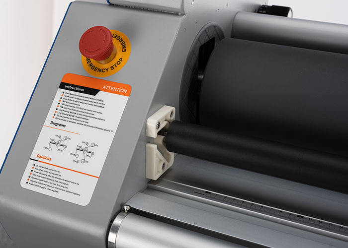 Reset emergency button on an industrial roll laminator control panel