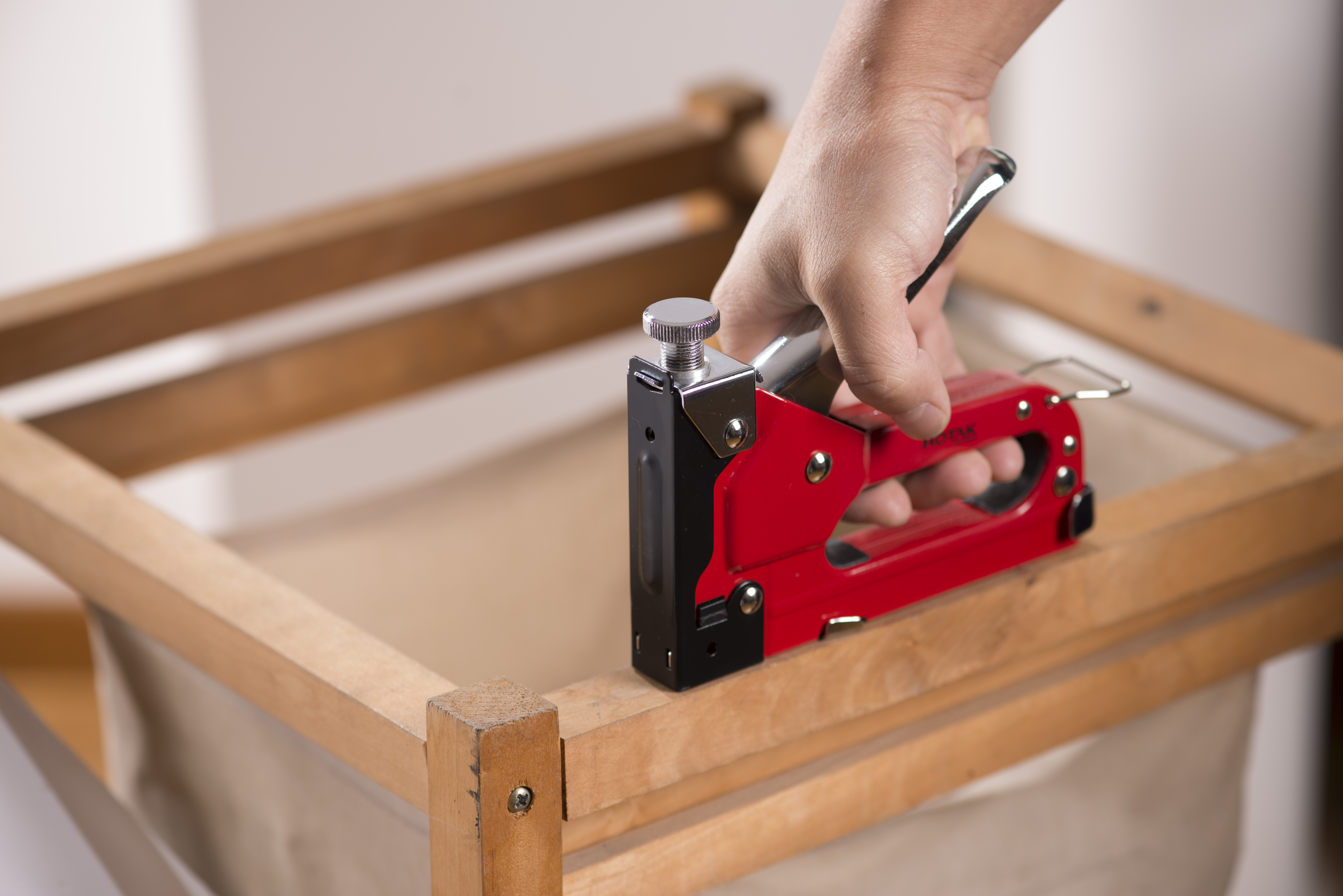 Staple gun applied to sheet material and cable fastening during installation work