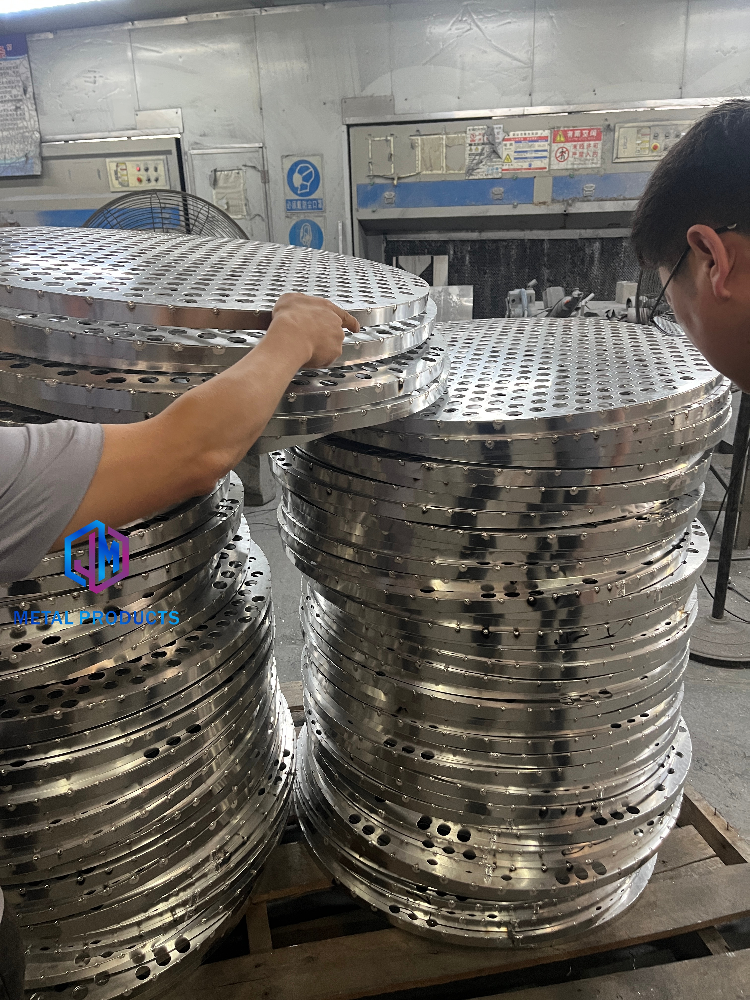 perforated metal panels in an architectural mesh production facility