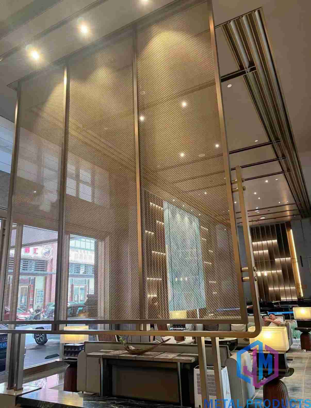 Woven wire mesh partition with bronze finish used as an interior space divider