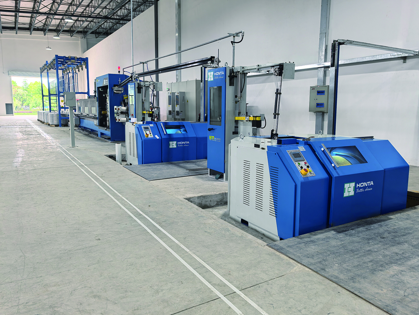 Complete wire drawing production line workshop scene showing HONTA machinery in an industrial environment