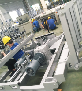 Glass edge grinding station in a glass production line driven by gear reducers