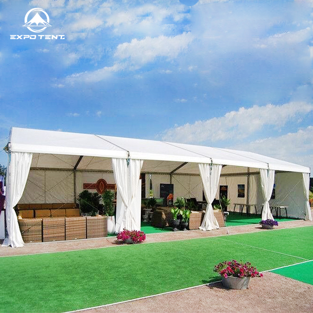 A spacious and elegant party tent setup for a large gathering