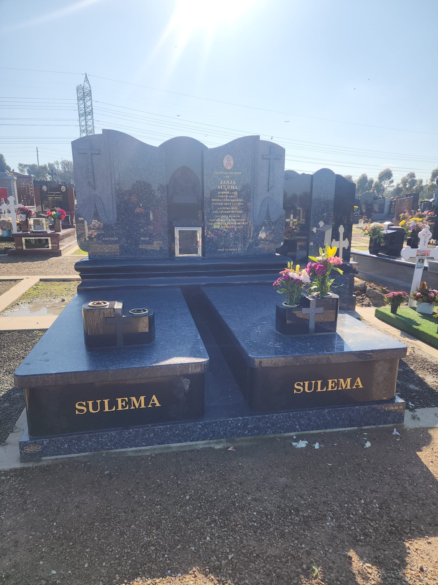 Granite tombstones installed in a cemetery, illustrating real outdoor application
