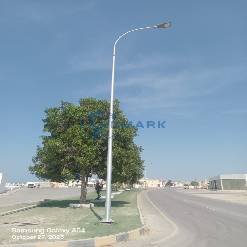 A sleek aluminium light pole in an urban setting