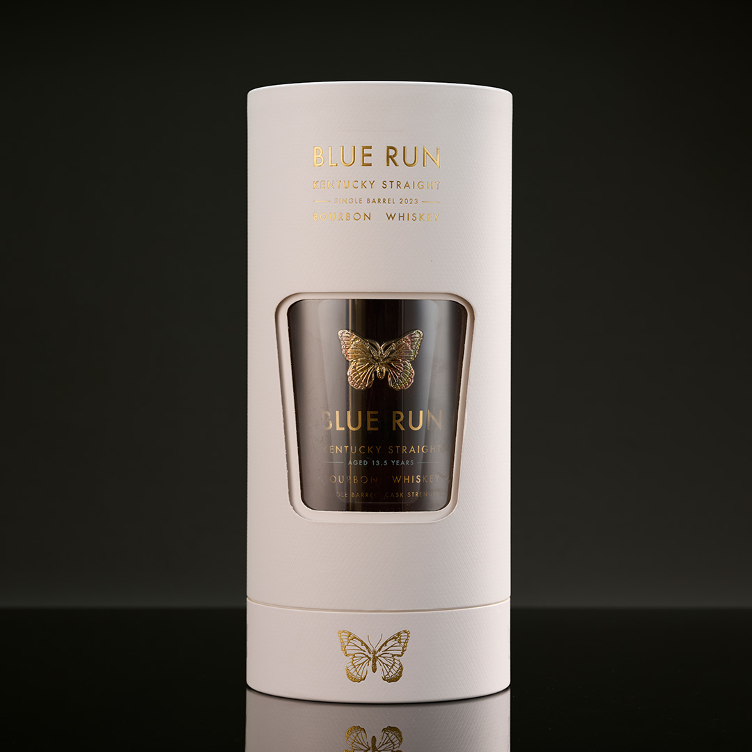 Rotatable cylindrical premium packaging developed as a follow-on whiskey gift box format