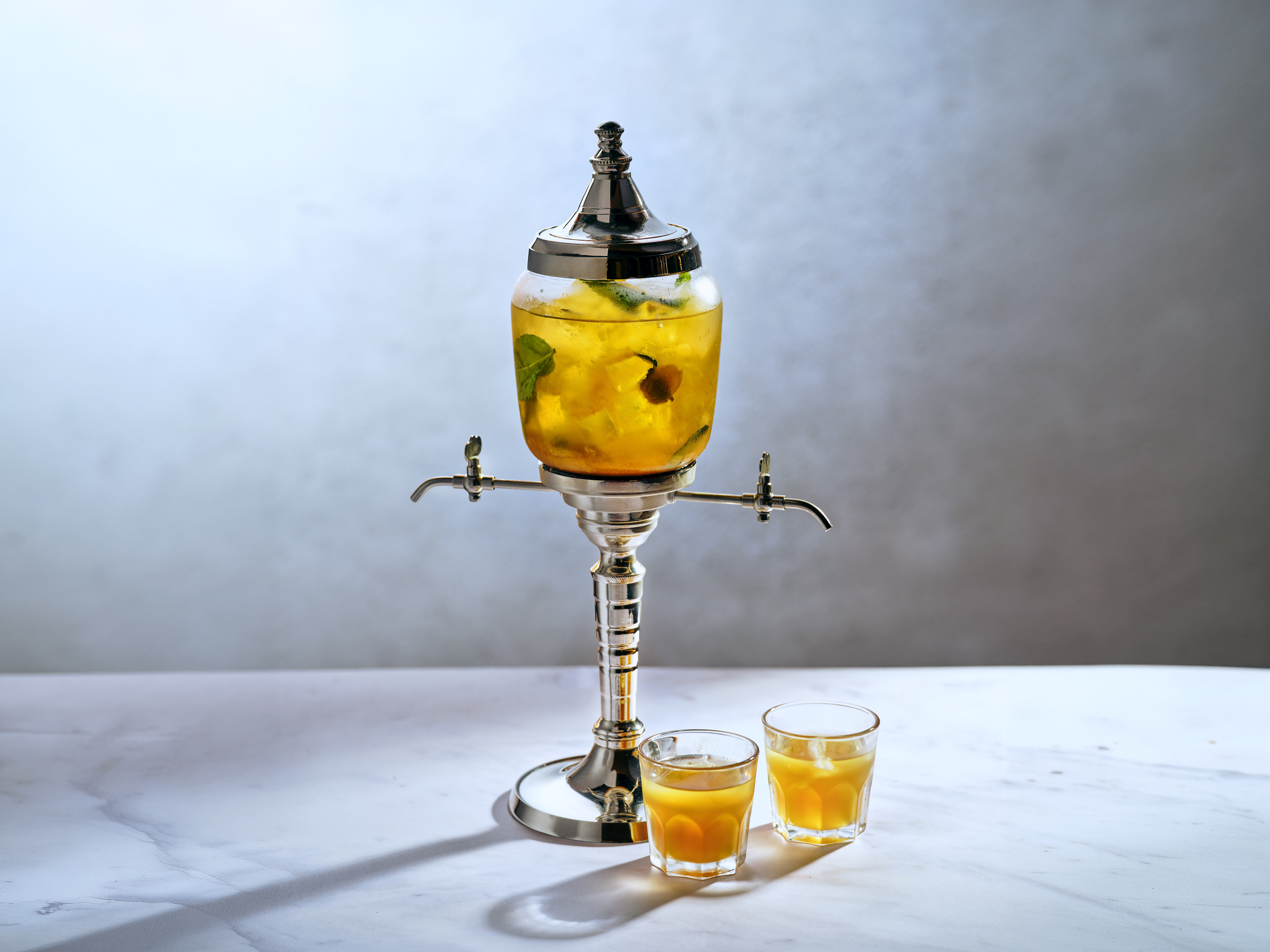 Fountain of Youth Cocktail with fresh lime and mint garnish, side angle