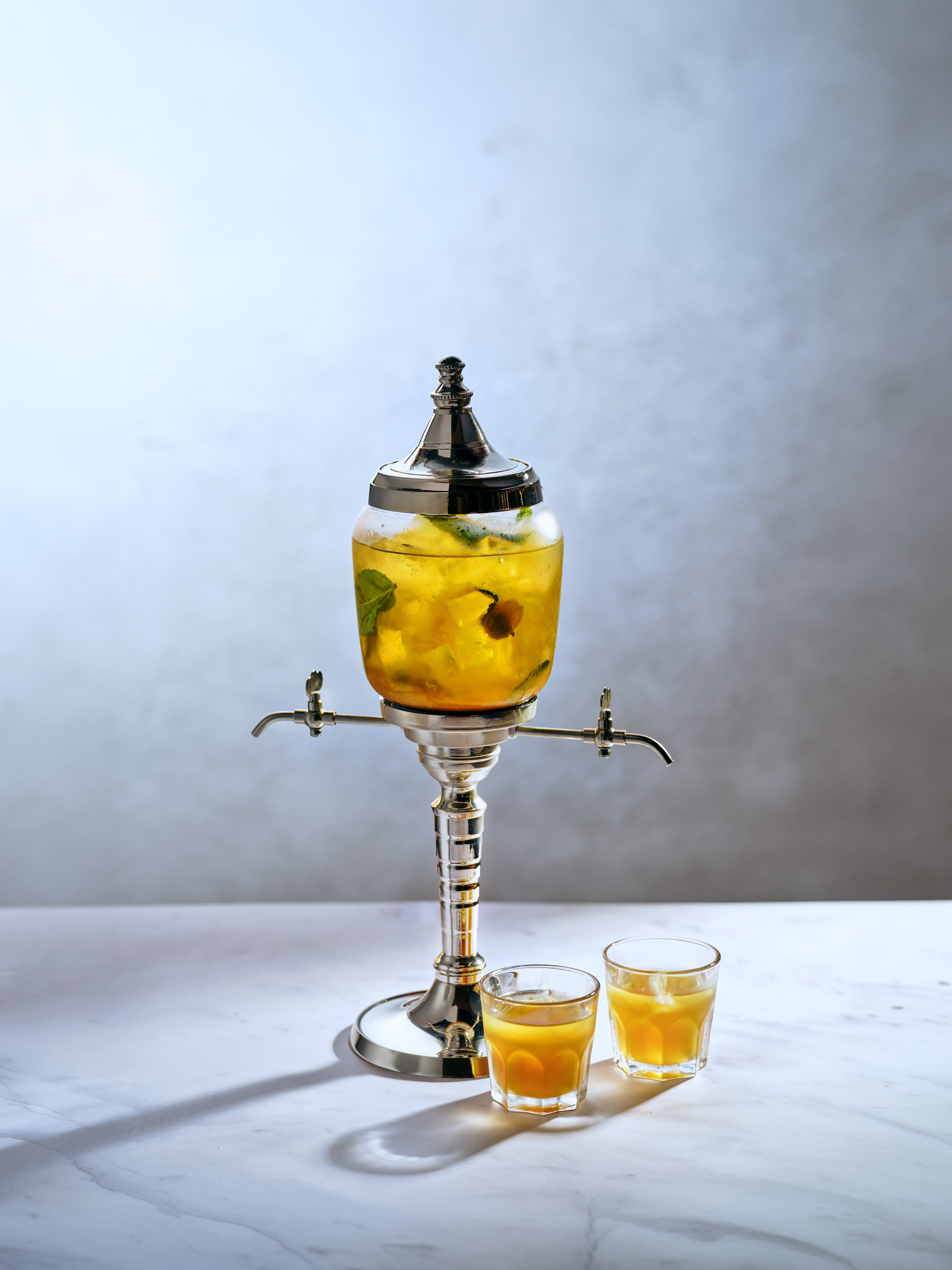 Fountain of Youth Cocktail served in sleek thin rocks glass with sun-kissed orange-gold liquid