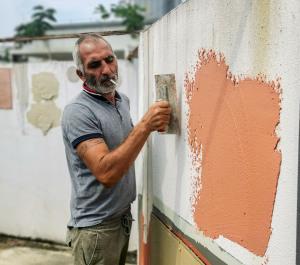 French personnel applying Simon products at a factory site.