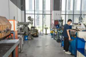 Worker Operating Machining Equipment in Modern LNB-BRG Manufacturing Workshop