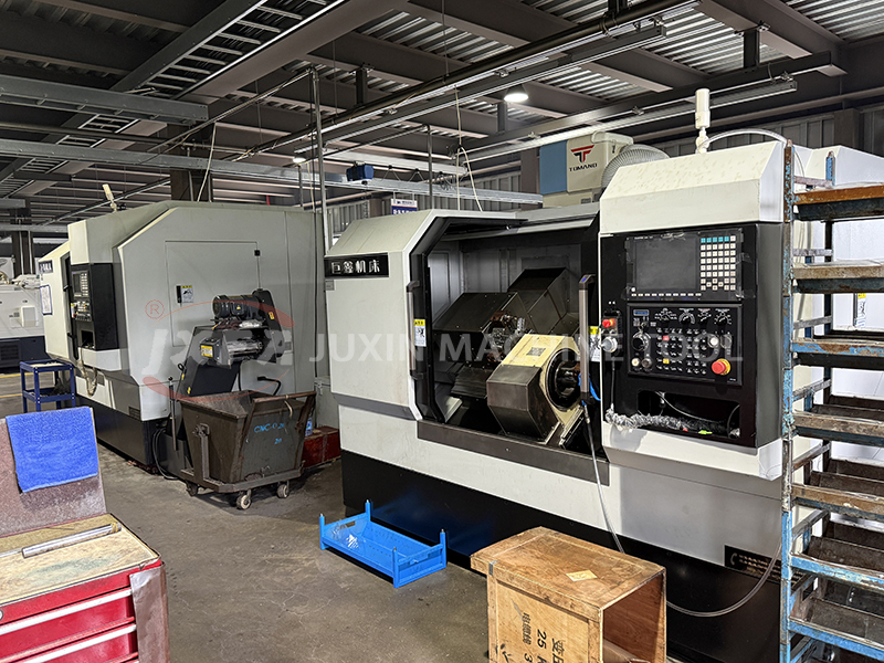 Drive shaft machining on double-head CNC lathe at Juxin facility