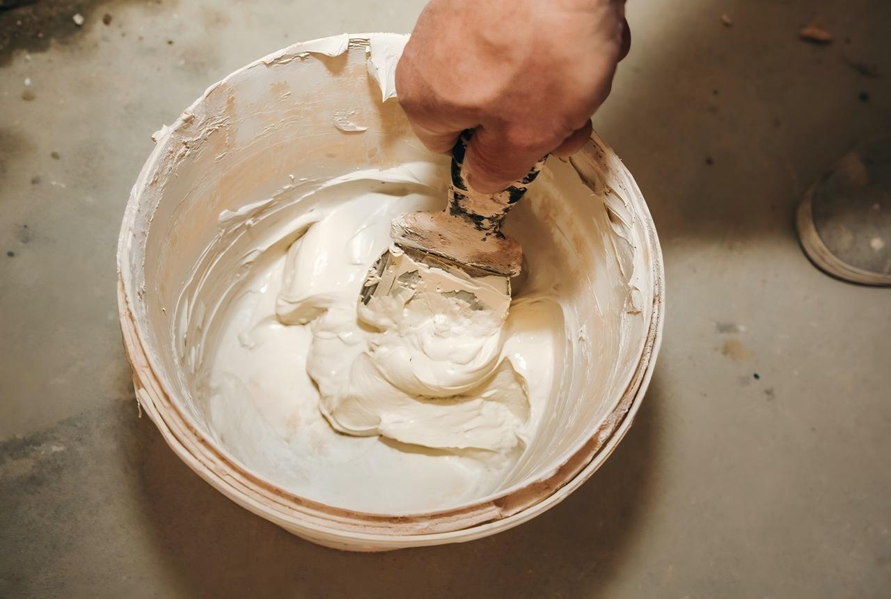 Wall putty being applied to an interior wall surface