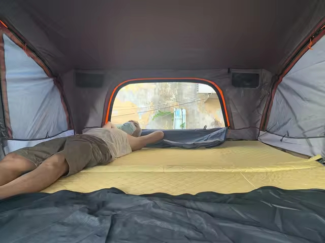 Rooftop tent in use on a vehicle supported camping trip