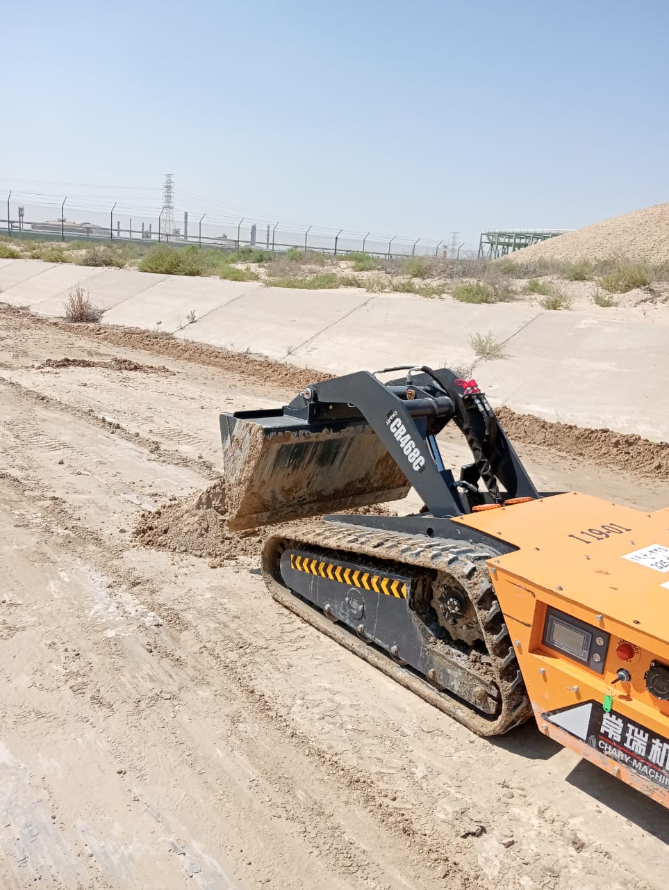 Minidozer operating in a narrow tunnel environment for cleanup tasks