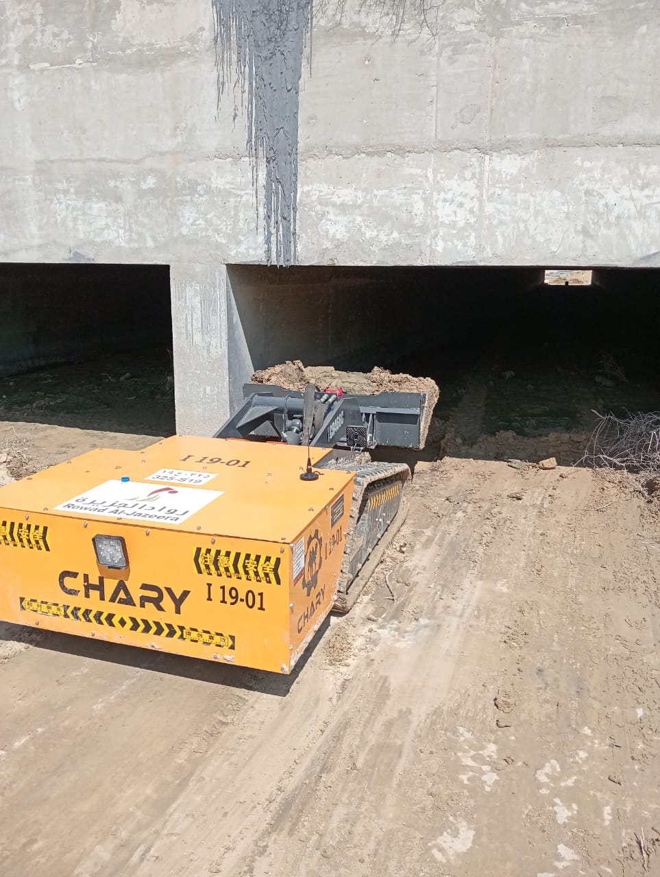 Remote-controlled electric minidozer working in a narrow underground tunnel