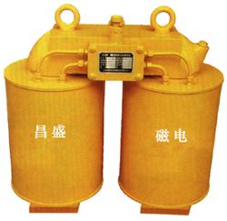Suspended electromagnetic iron remover installed above a bulk conveyor in an industrial mineral processing line