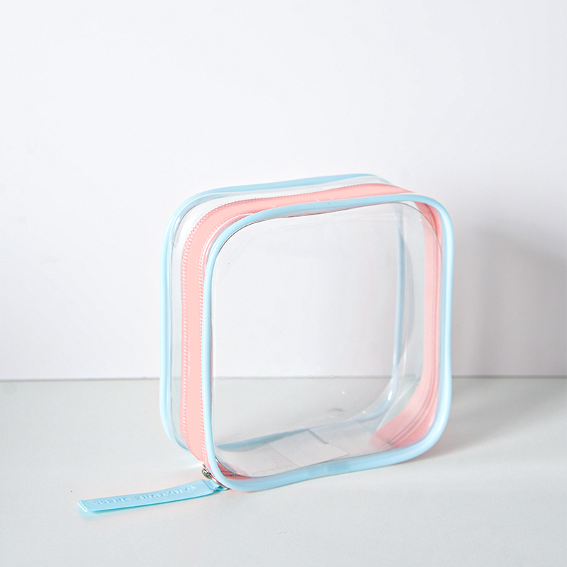 Clear PVC cosmetic pouch with colour-border trim on a white background