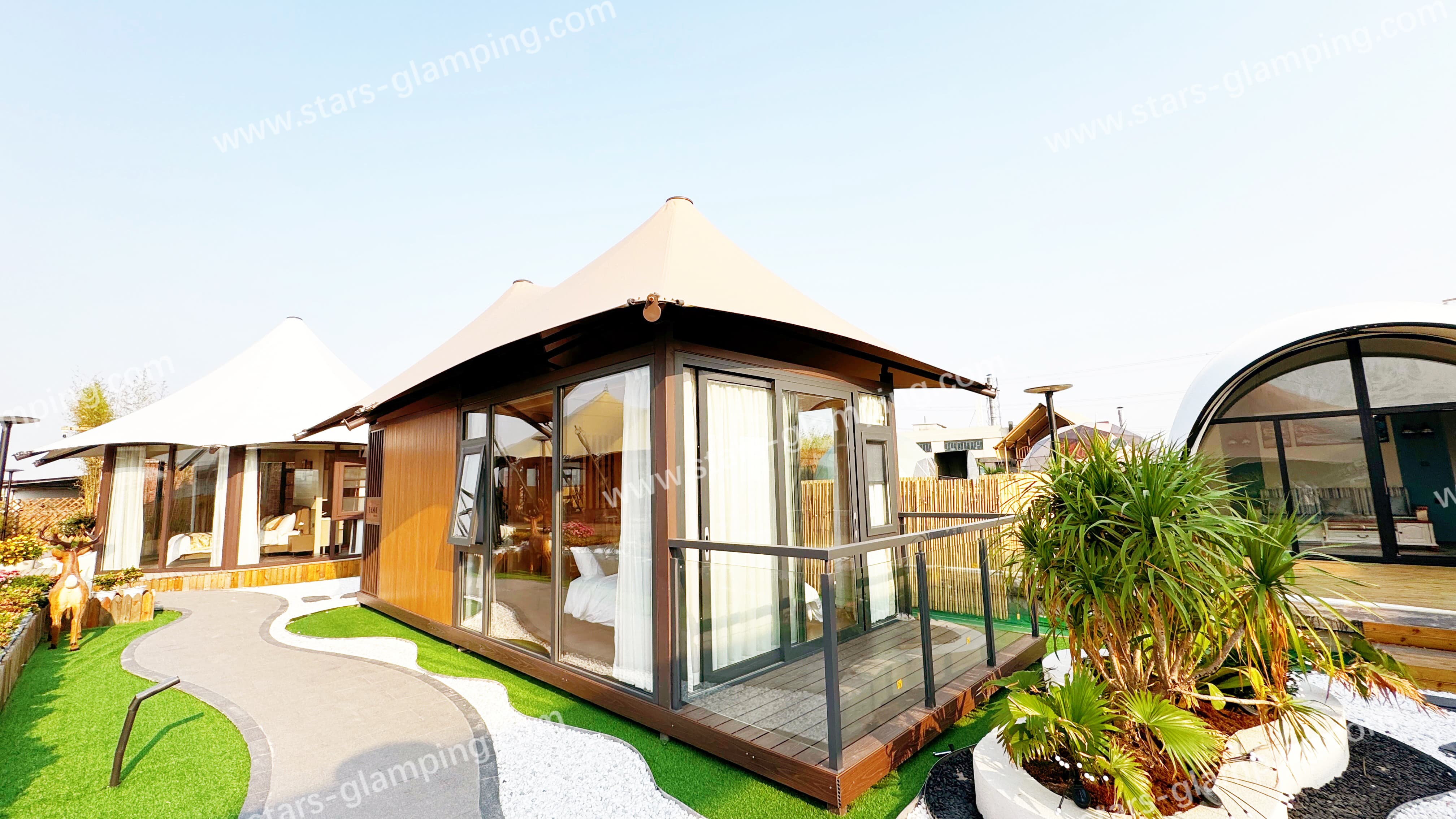 Luxury hotel tent Villa model installed in a mountain eco-lodge with large windows and wooden deck