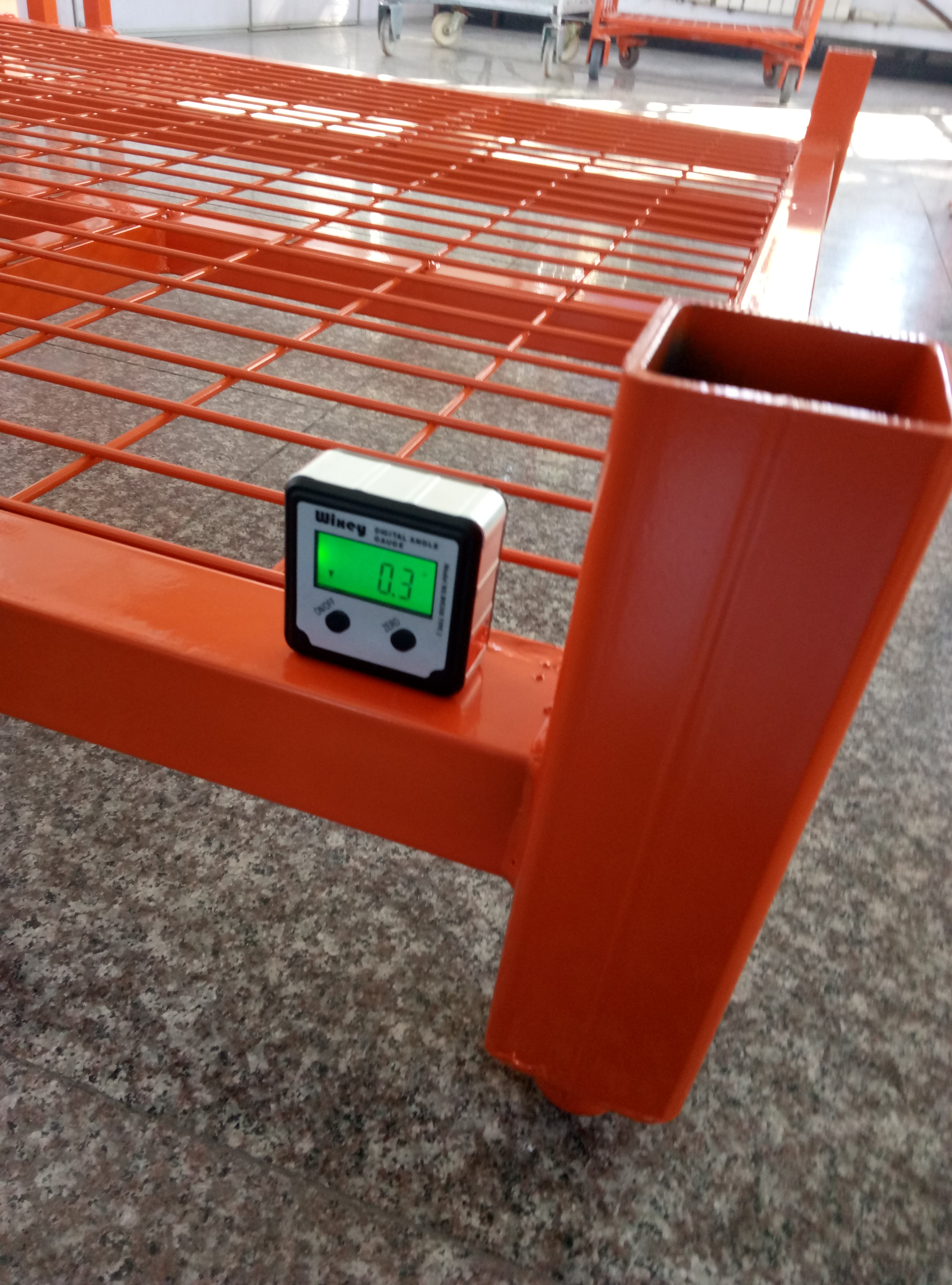 Storage rack base levelness inspection before a stacking rack is released for shipment