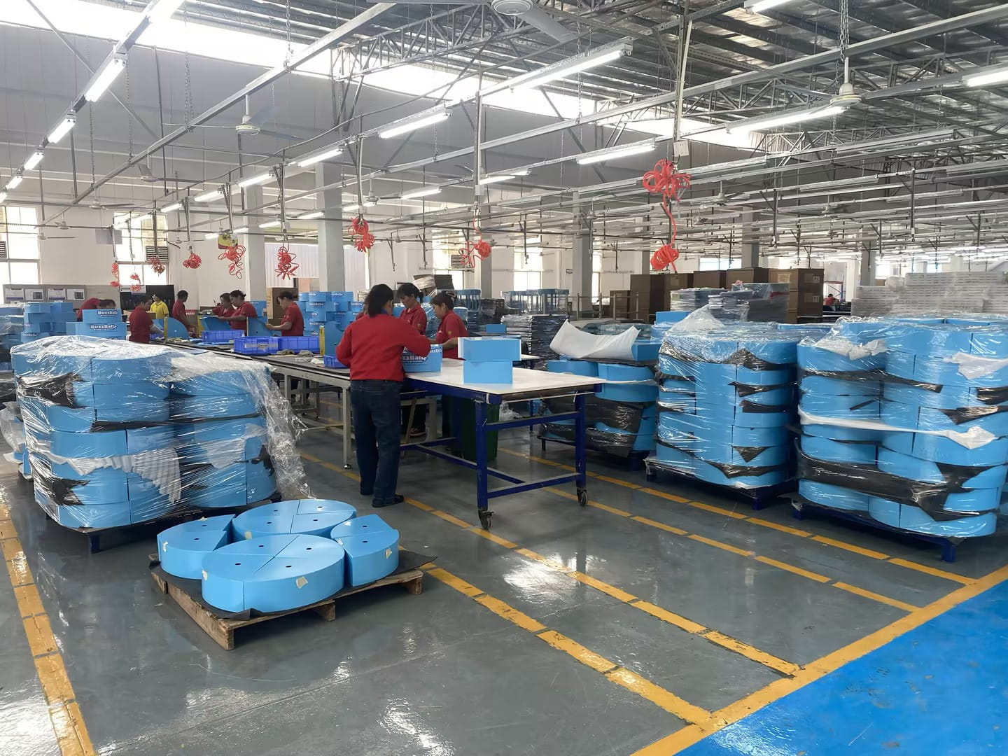 Packing line for display fixtures prior to export shipment