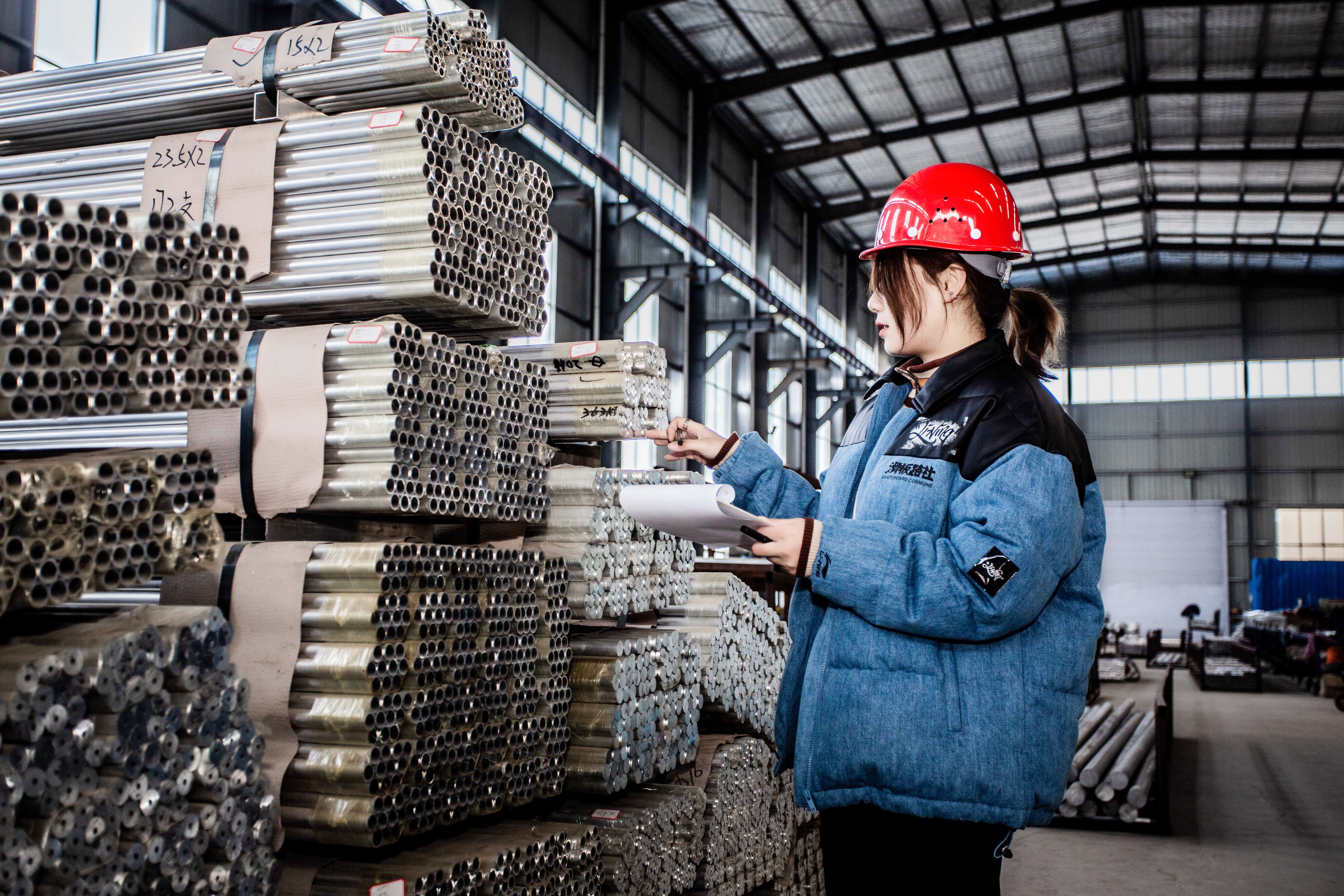 Quality inspection staff examining aluminum busbar products