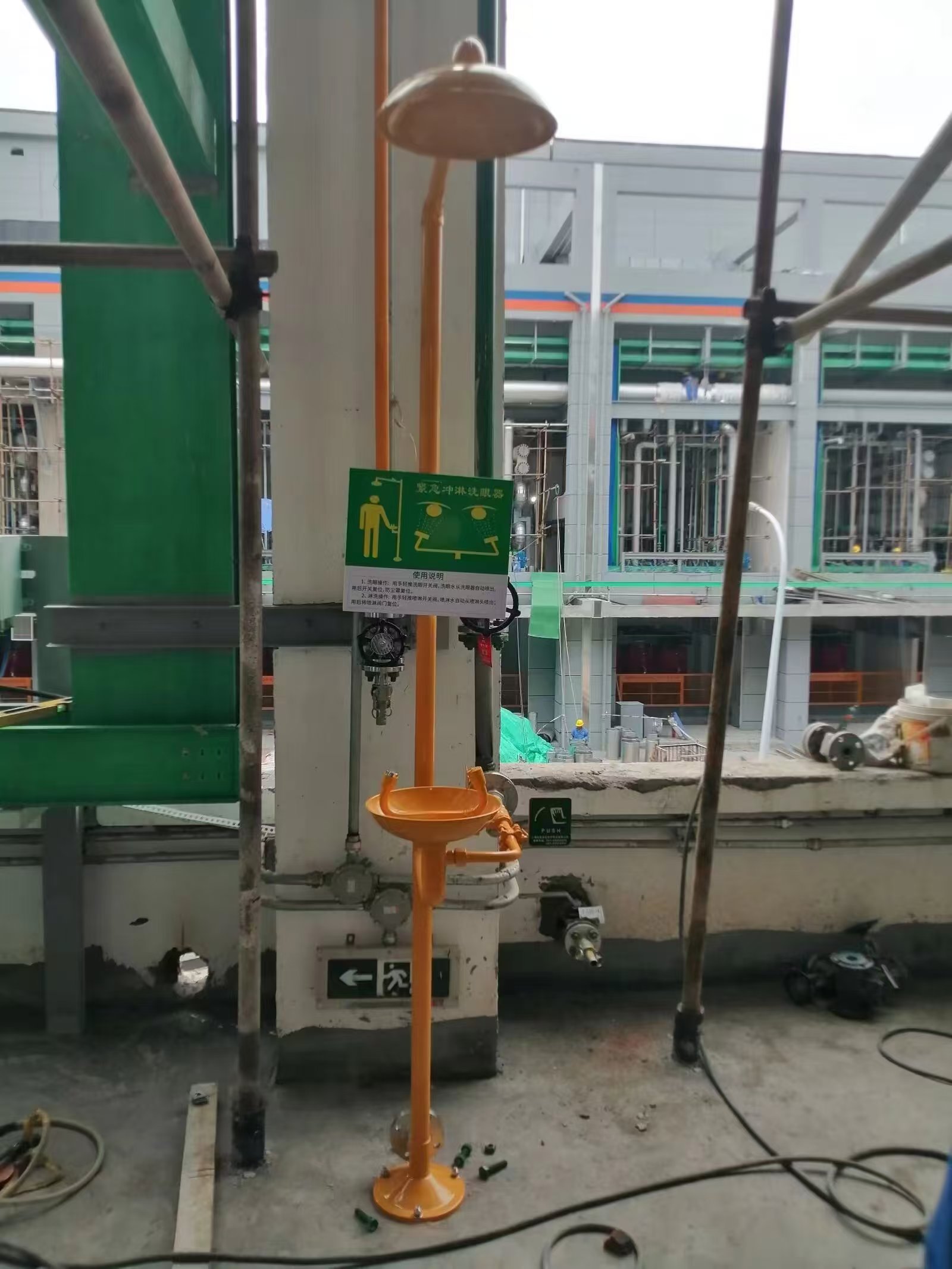 Compound emergency shower and eyewash installed in a chemical facility