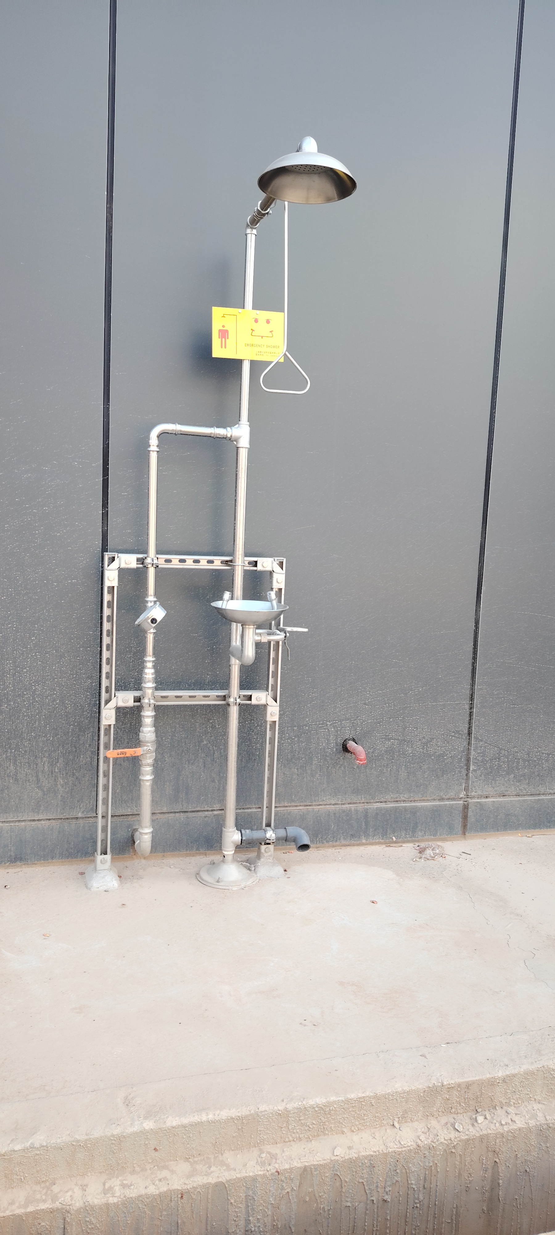 Compound emergency shower and eyewash in industrial setting