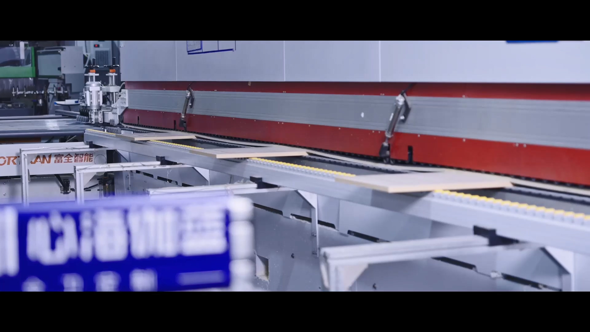 Sheet edge sealing machine closing plywood panel edges in a bathroom vanity factory
