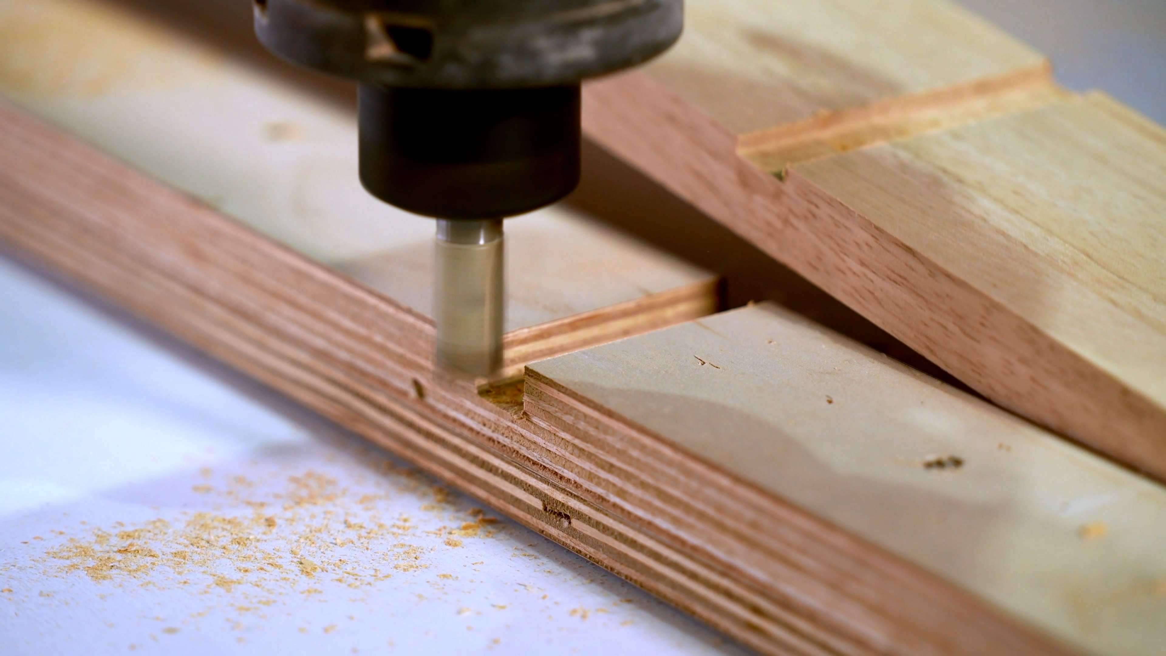 Machine slotting operation forming panel joints for wood bathroom vanity construction