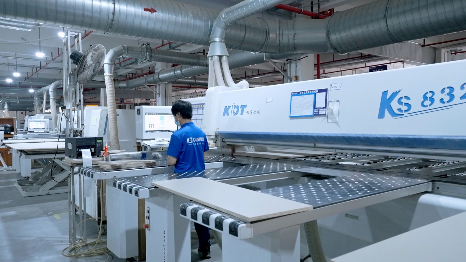 Workers operating production machinery at the SHKL manufacturing base