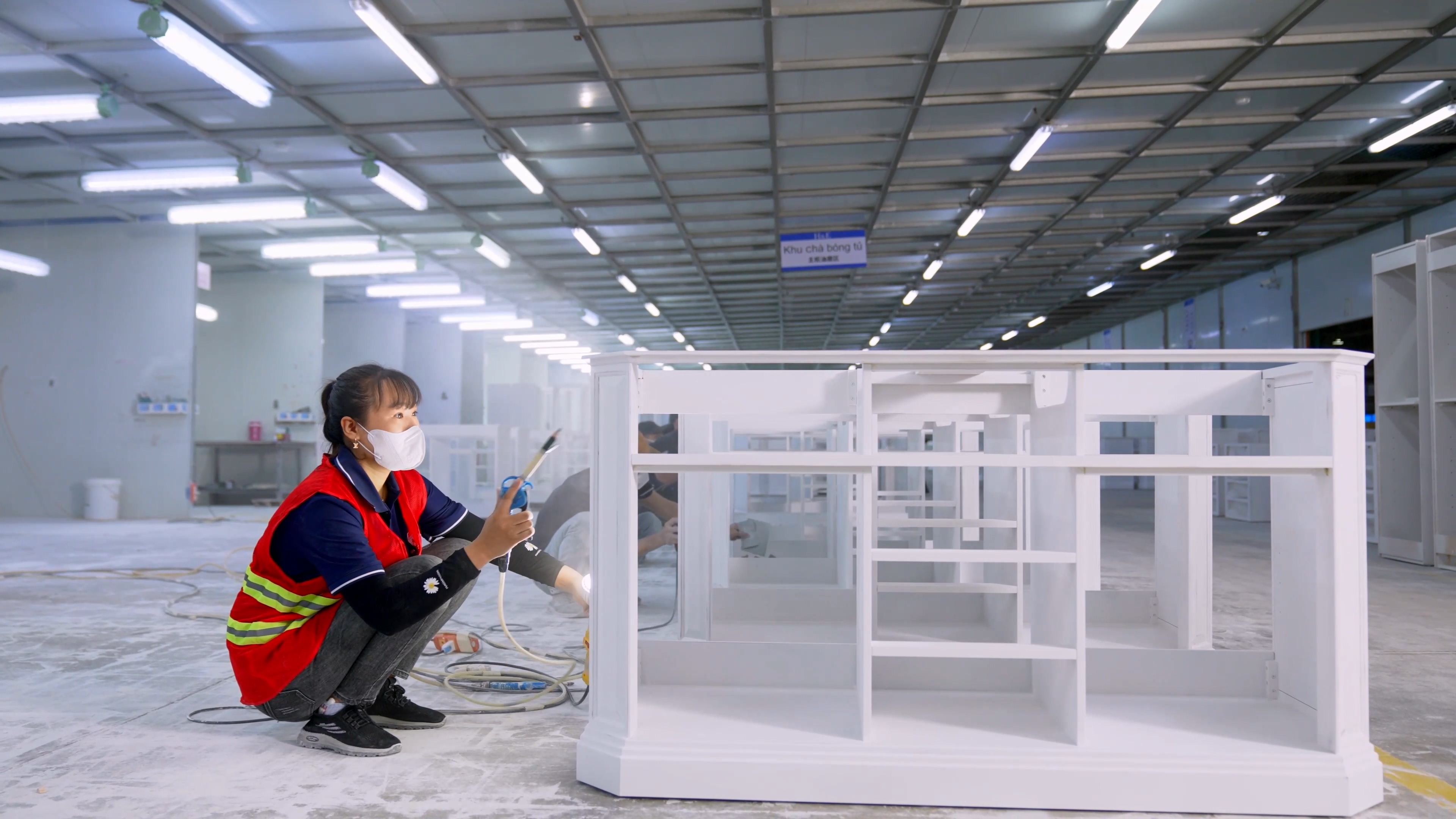 Quality inspection of semi-finished bathroom vanities during the spraying process at SHKL factory