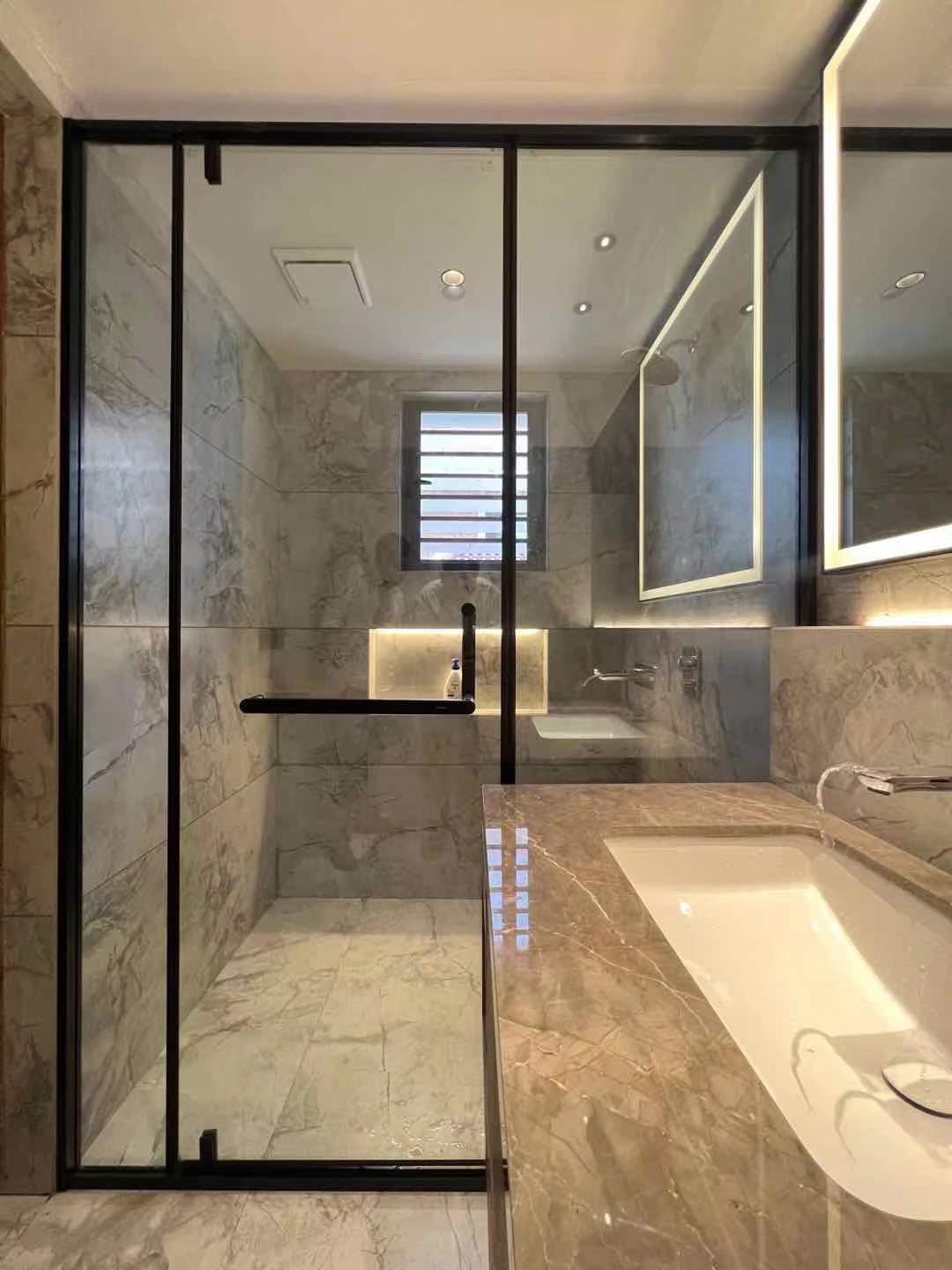 glass shower door installation in a modern bathroom