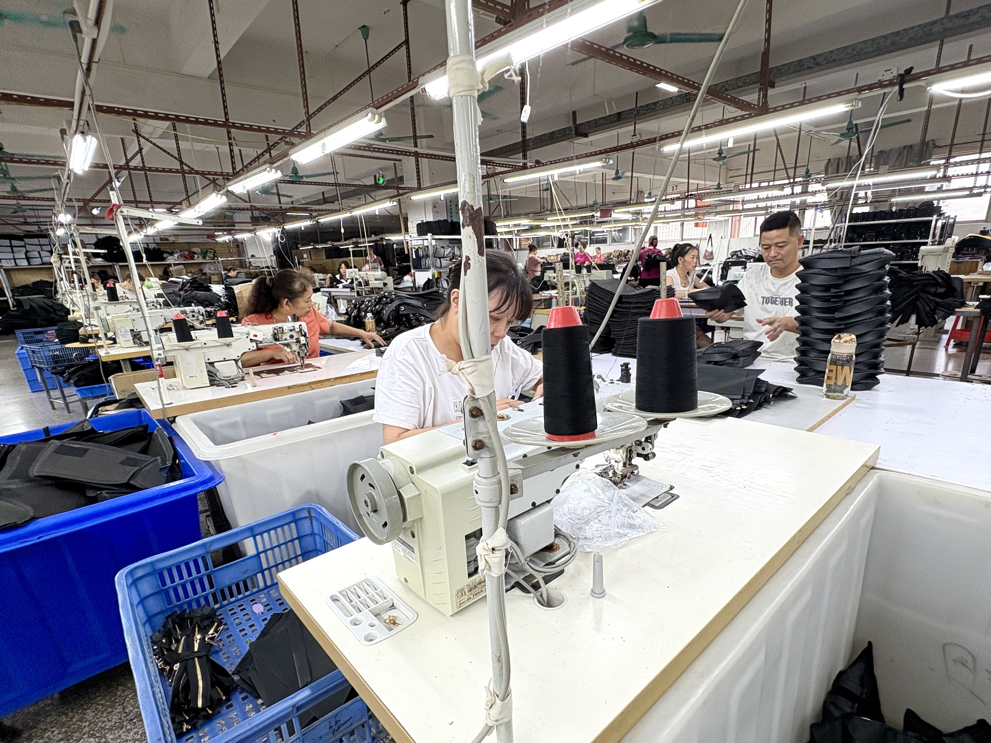 Leather goods sewing process in a factory