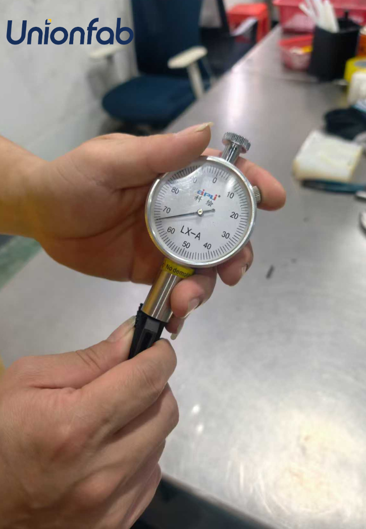 Unionfab engineer checking part hardness with LX-A tester