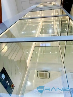 Platform lift installation in an existing commercial building using a shallow-pit aluminium frame configuration