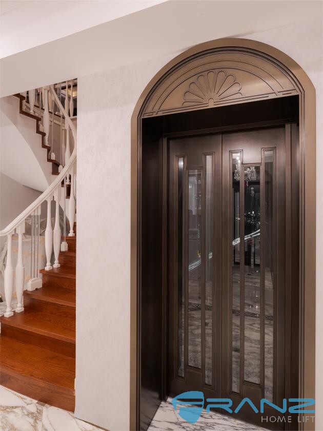 Shaft-built premium home lift cabin with panoramic glass wall installed in a villa
