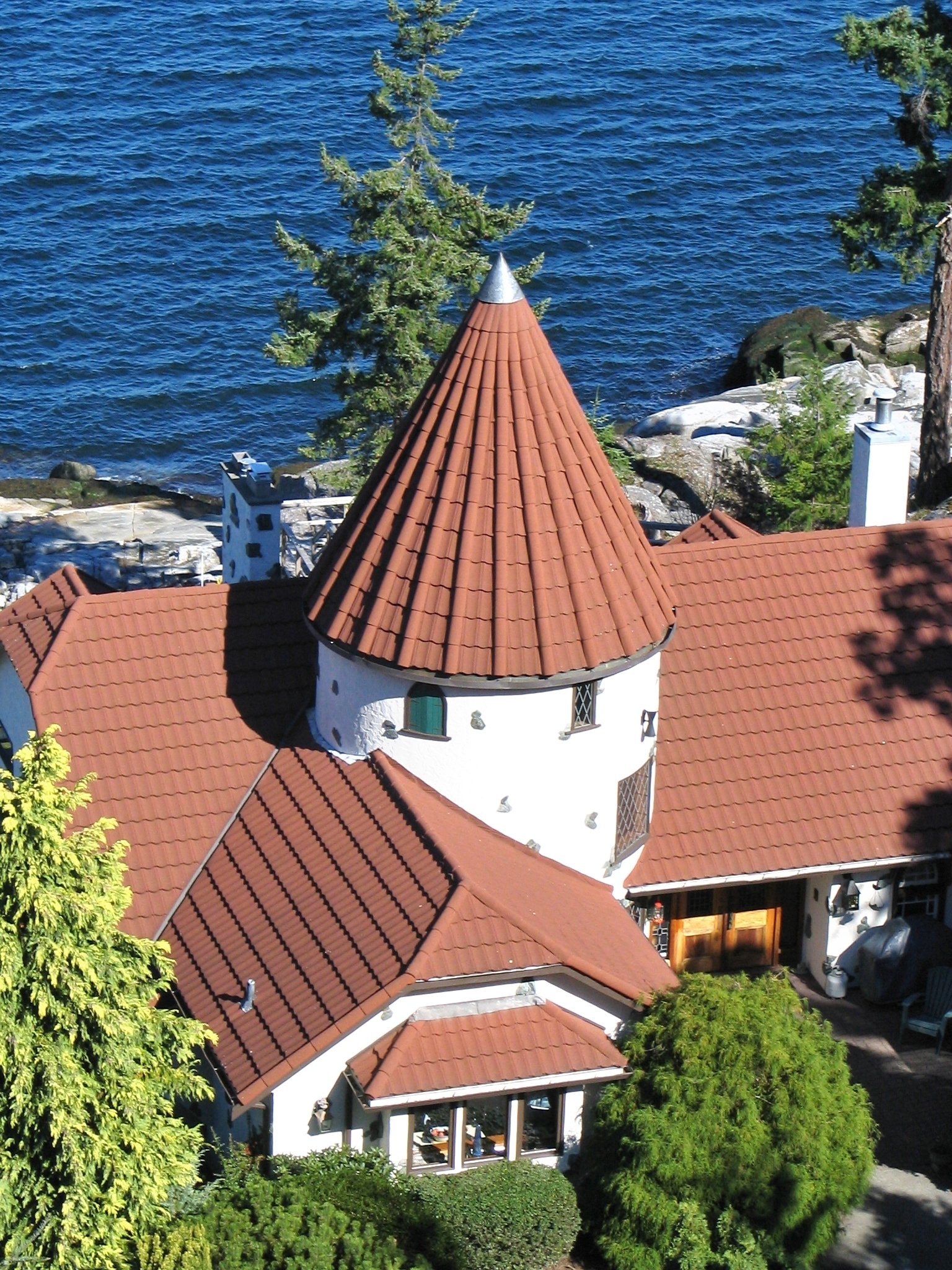 Coastal building with stone coated metal roofing tiles overlooking the sea