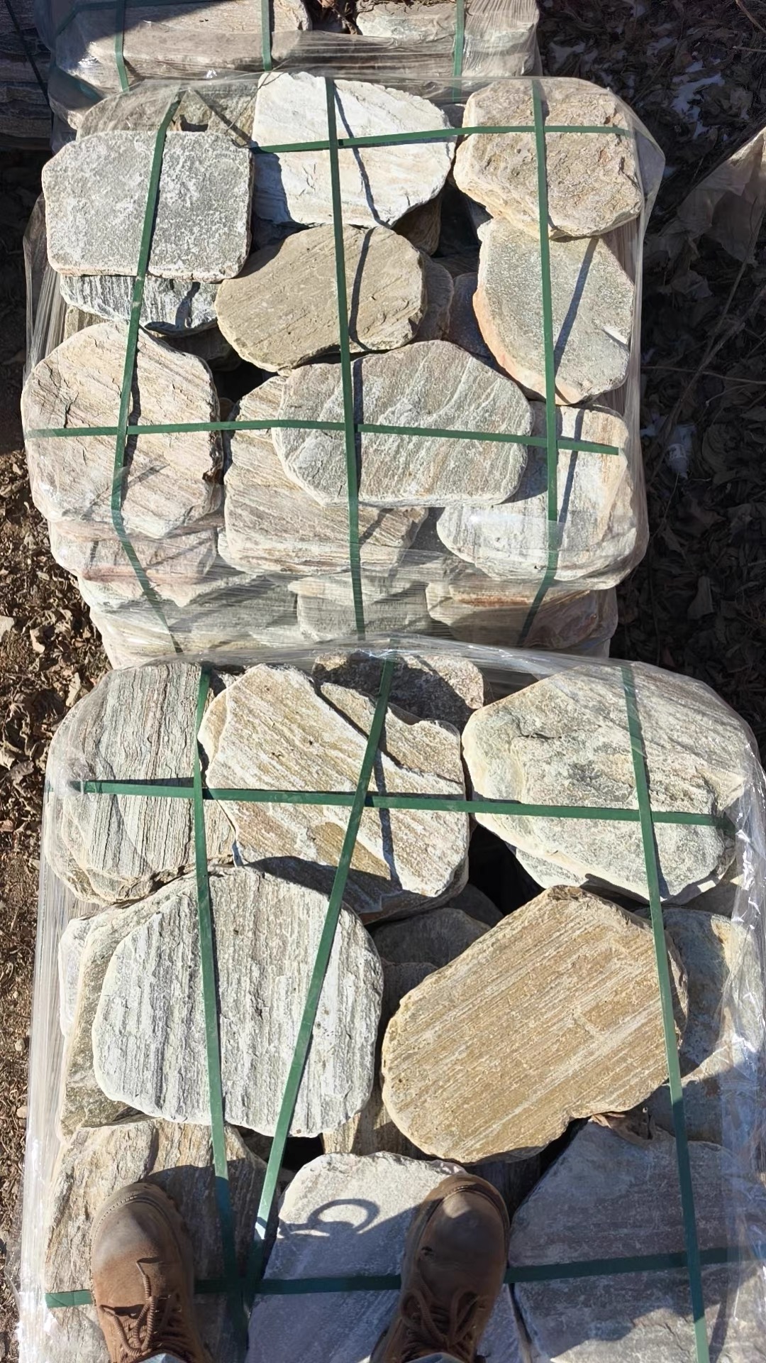 PET strapping applied to heavy stone slab bundles