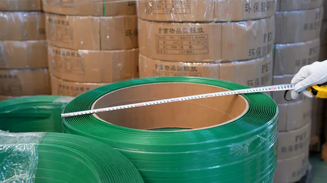 Length measurement check on plastic strapping during production, supporting cut-length consistency for fiber bale strap