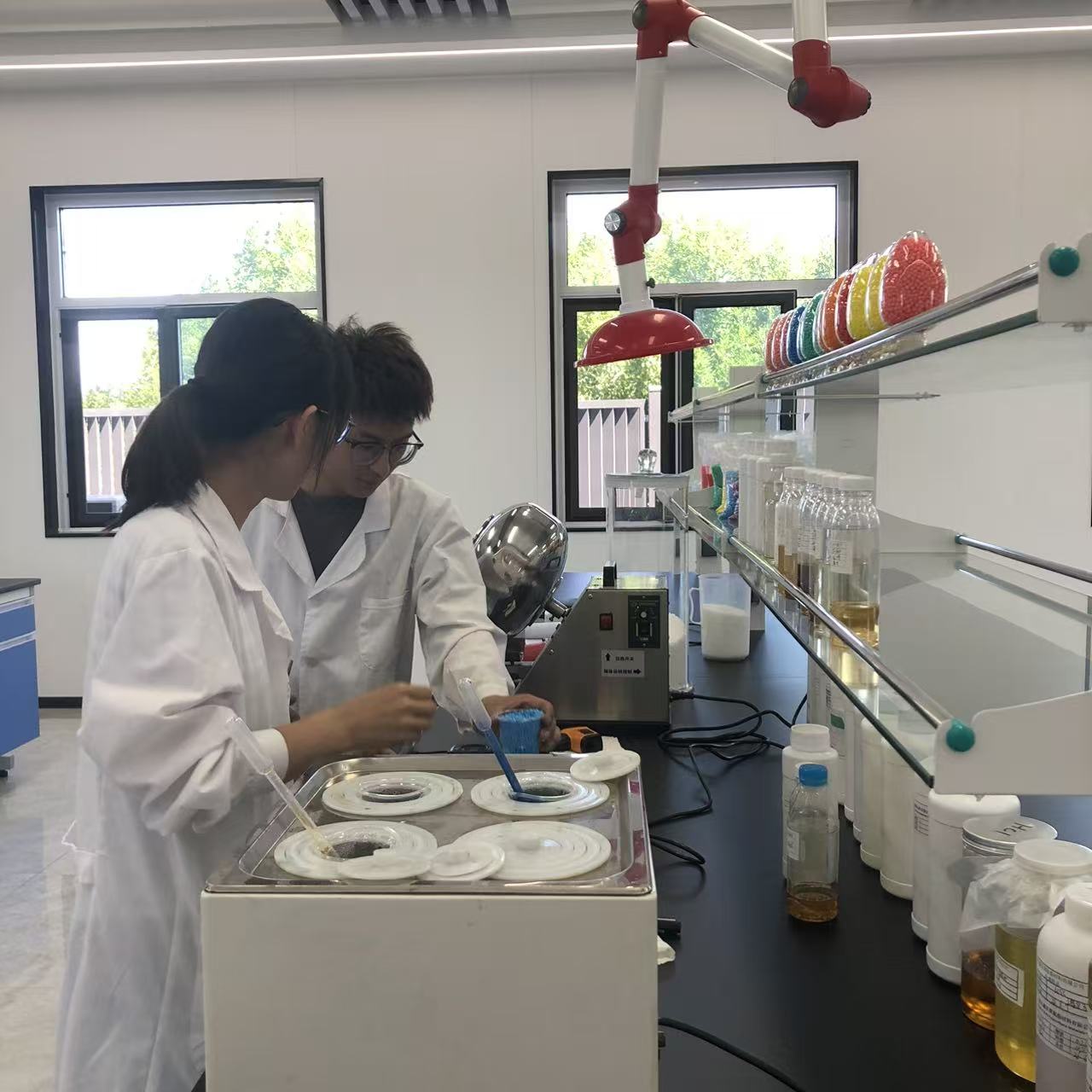 Laboratory technician testing polyester polyol viscosity and hydroxyl value